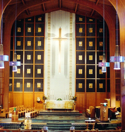 Organ screen containing carved plaques.