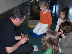 Pastor Elkin exploring the Languages bag with the kindergartners