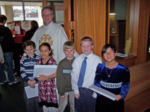 After their first communion, Makensi, Ben, Devin, Kameera and Stefan greeted the congregation with the pastor.
