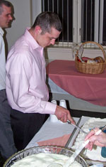 Matthew Wellen cutting the cake