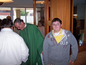 Dustin Pelleschi greets the congregation with the Pastor