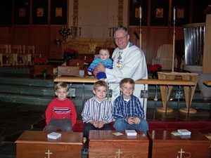 Pastor Elkin with several children who will remember their baptism with a faith chest