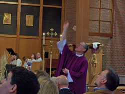 Pastor Elkin pointing out features in the windows