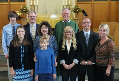 New members:  the Schreckengast and Fortin families with Pastor Elkin