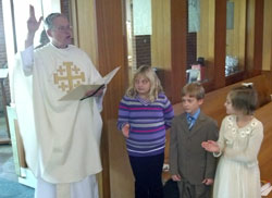 Pastor Elkin with Gabriella, Abbigail and Owen greet congregation