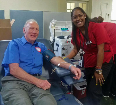Lou DeSeau giving blood