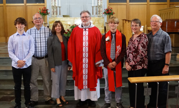 Levi Ott with his family and Pastor Vasey